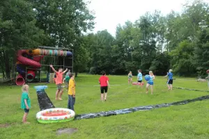 Students playing slip and slide kickball