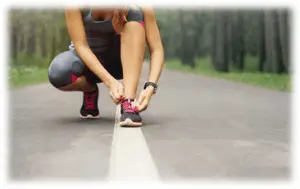 Runner tying her shoe