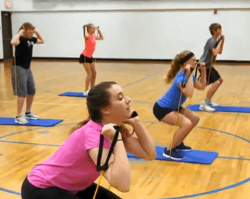 Students performing resistance tubing exercises
