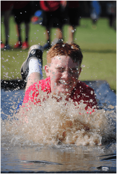 Student using slip and slide