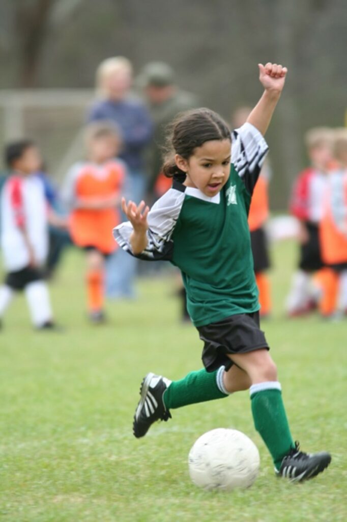 A young students playing soccer